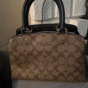 Coach purse comes with long strap and has 4 compartments